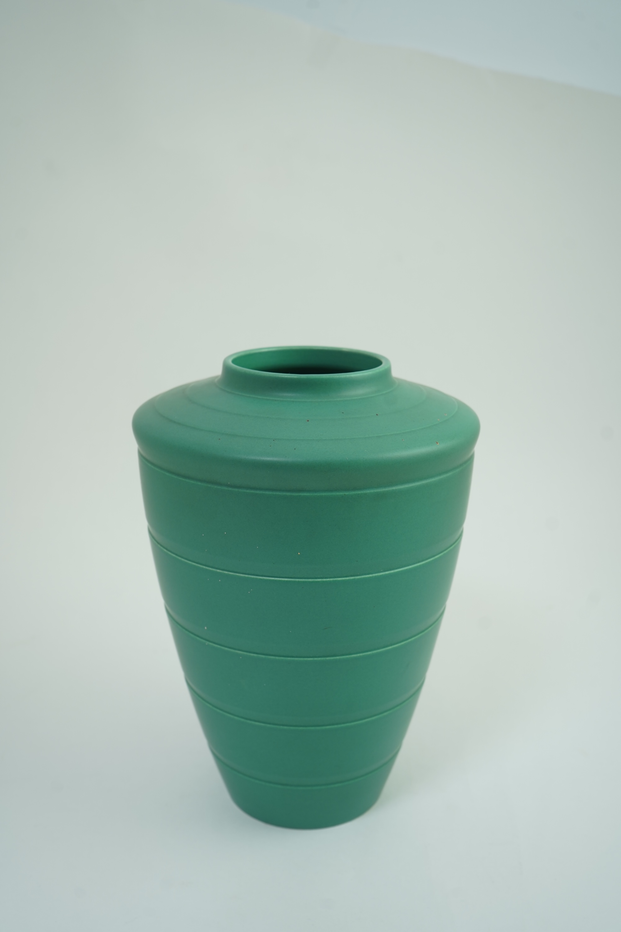 Keith Murray MC RDI FRIBA (New Zealand/British, 1892-1981) for Wedgwood: A matt green glazed tapering vase